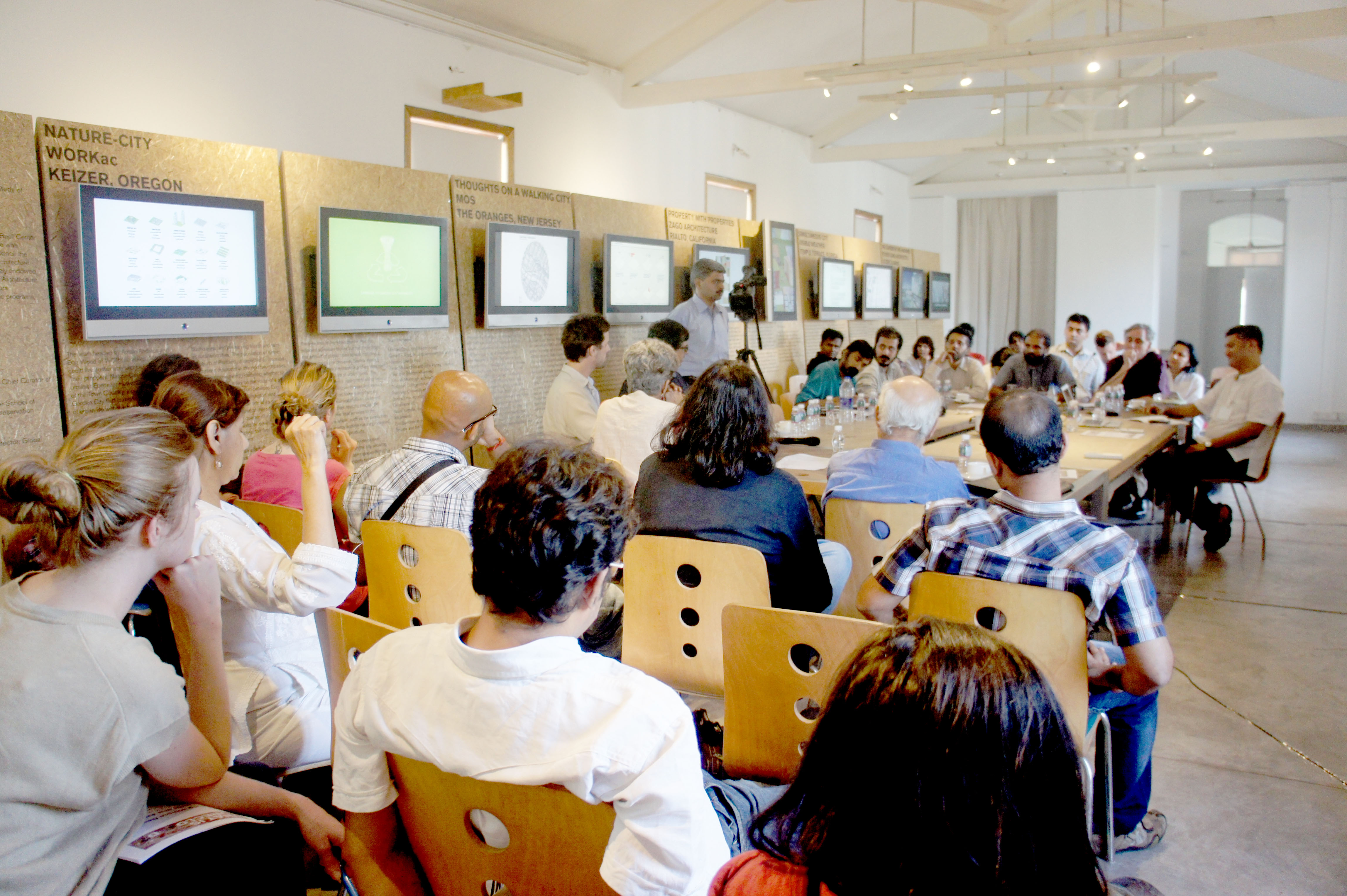 A photograph of people seated at a workshop