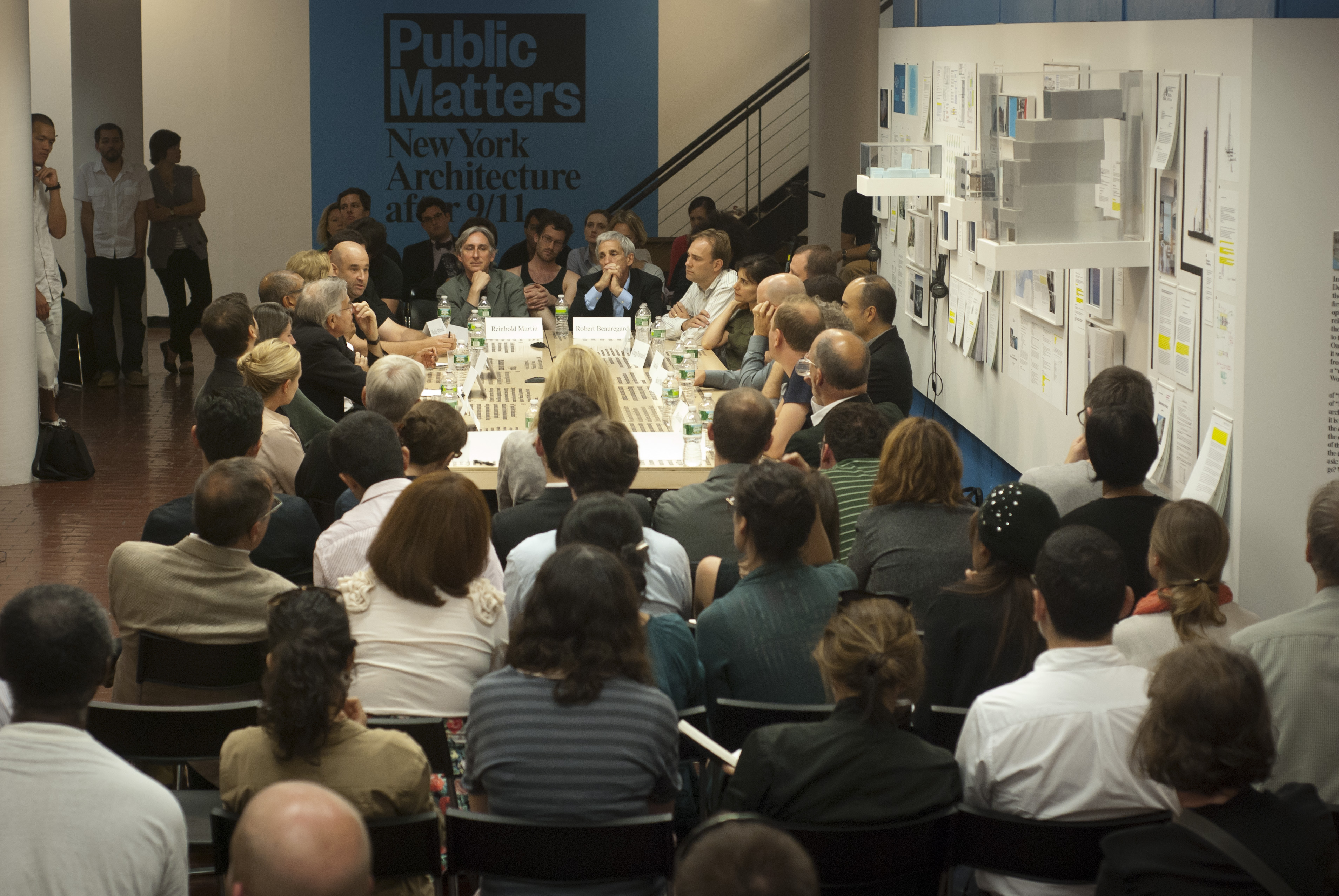A group gathered for a discussion around a large table