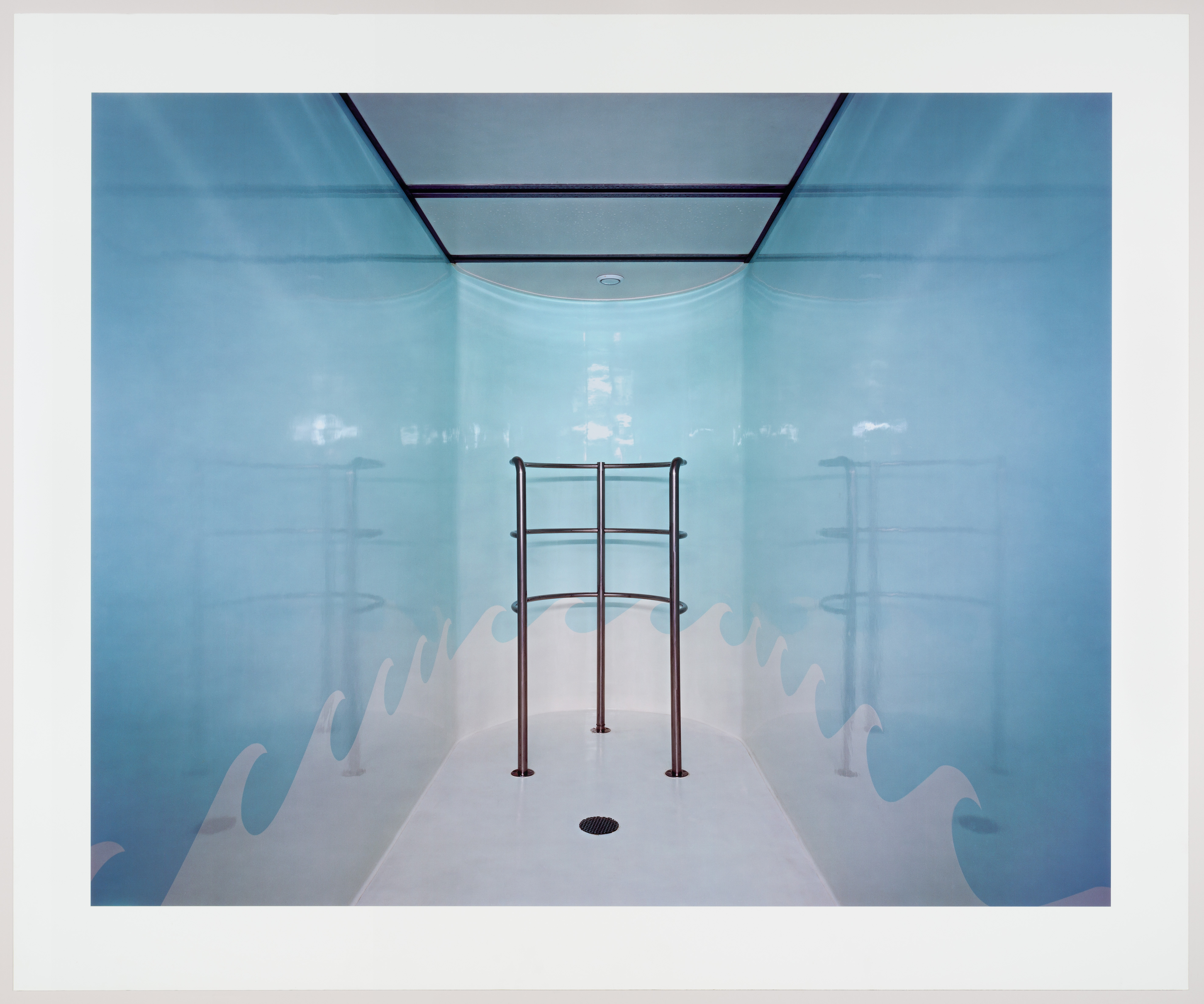 Photograph by Lynne Cohen of an interior space with reflective light blue walls