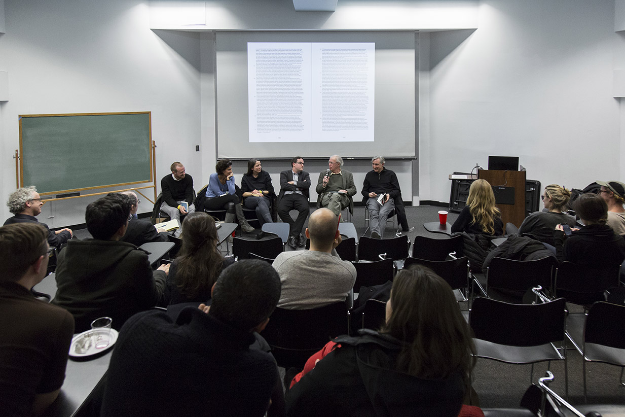 An image of a group of people gathered around in discussion