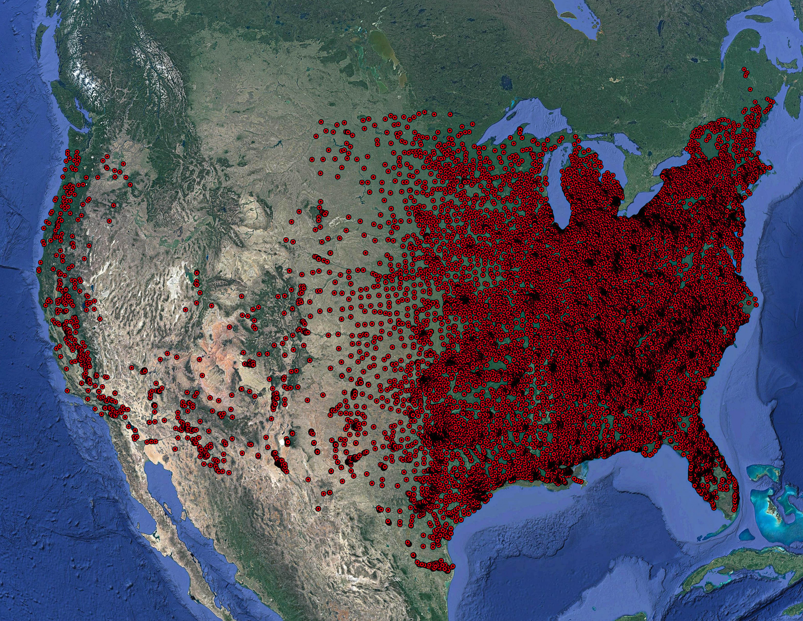 An aerial topographical photograph with red points, primarily clustered on the eastern half of the continent