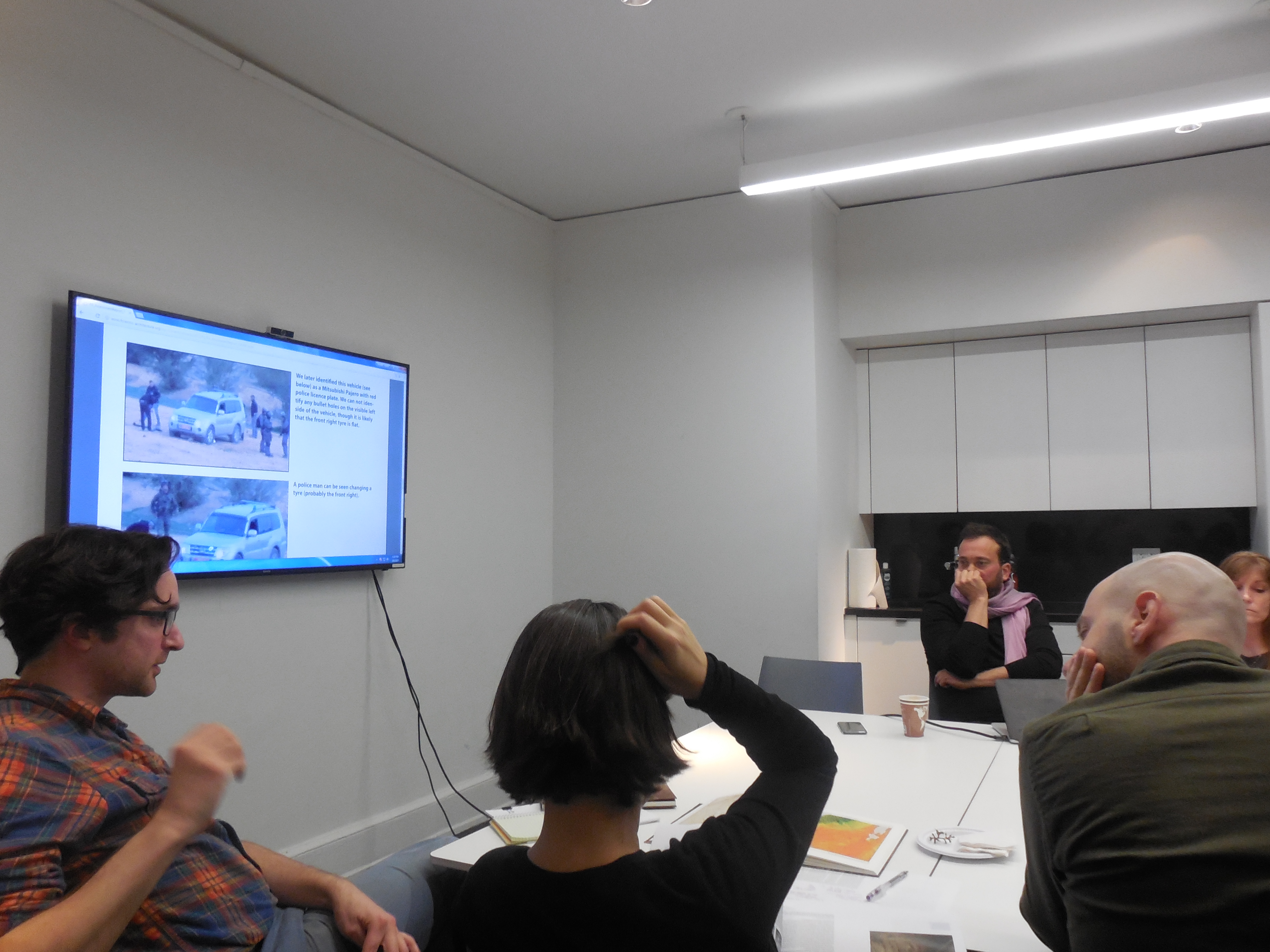 A group gathered seated around a conference table