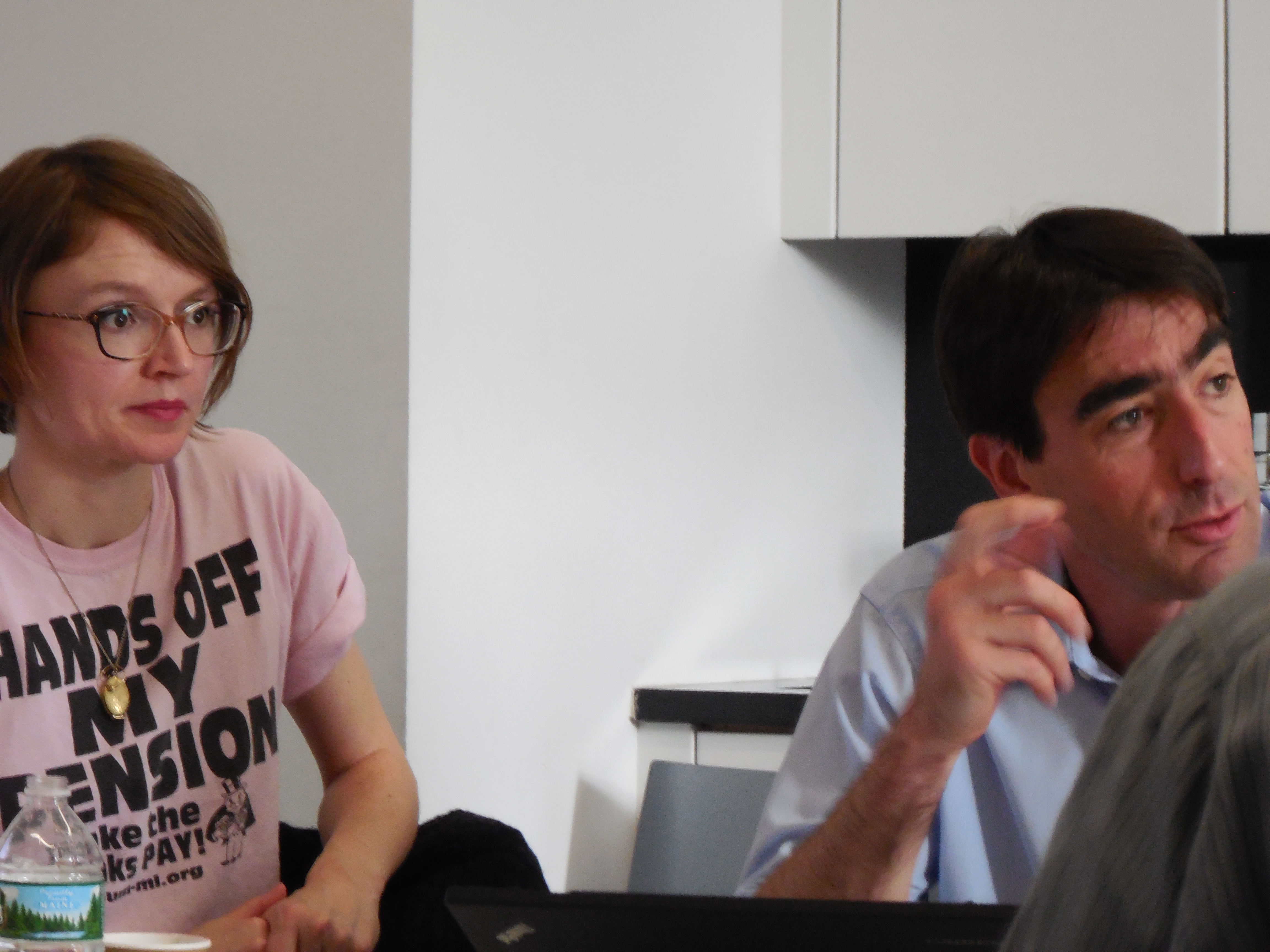 Two people engaging in conversation while seated at a table
